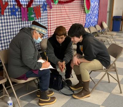 Diane Selanoff, Rhoda Moonin, and students singing Port Graham 2023
