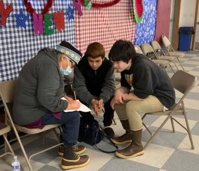 Diane Selanoff, Rhoda Moonin, and students singing Port Graham 2023